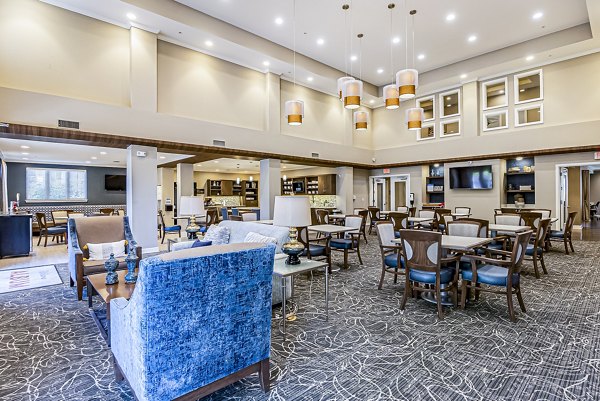 Clubhouse with modern design at Album Quail Springs Apartments, featuring lounge seating and social areas in a luxury setting