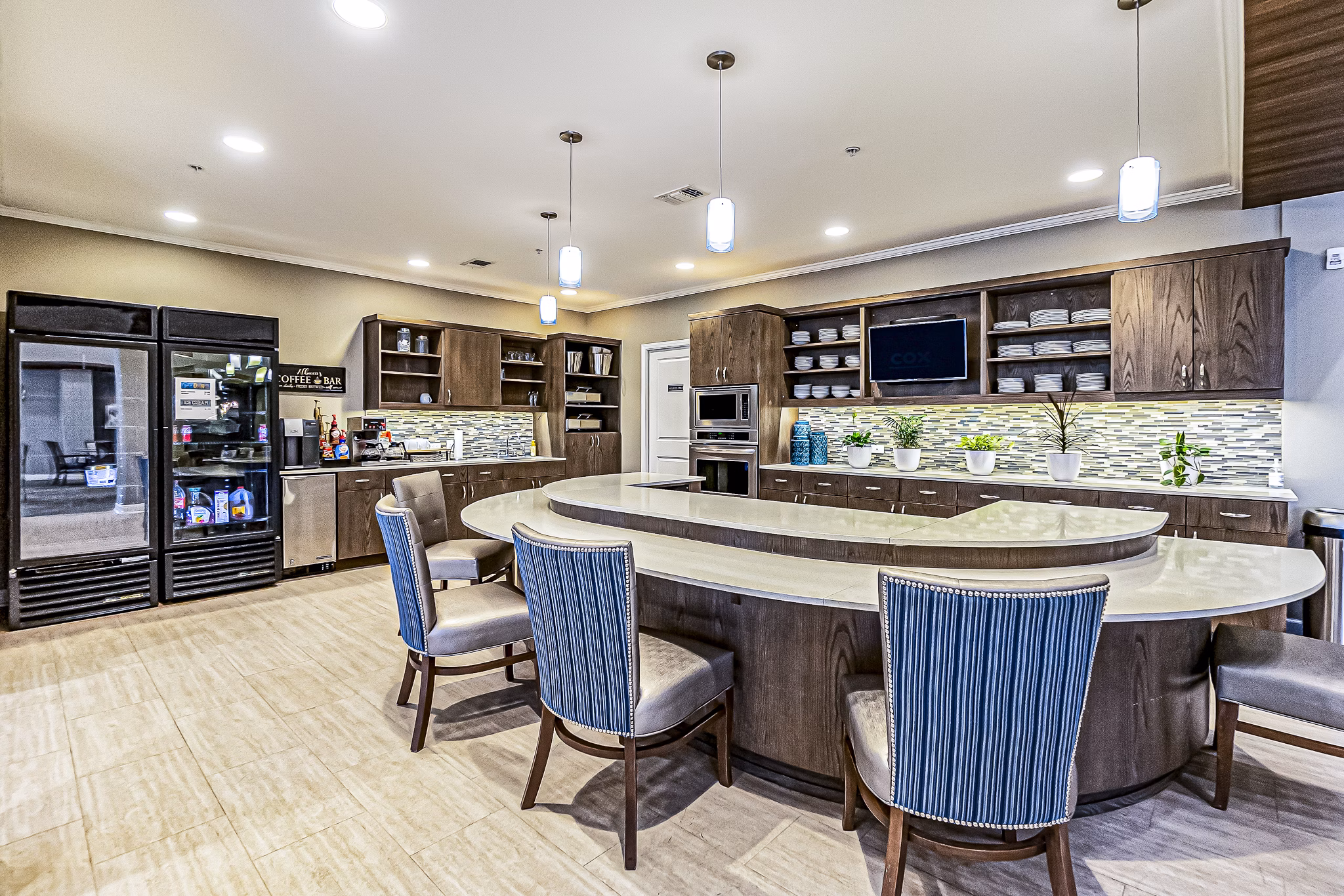 Chic clubhouse kitchen with coffee bar at Album Quail Springs Apartments, ideal for social gatherings and relaxation