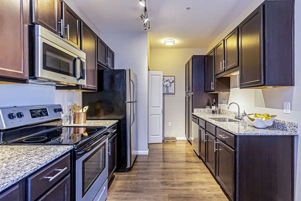 Modern kitchen with stainless steel appliances at Album Quail Springs Apartments