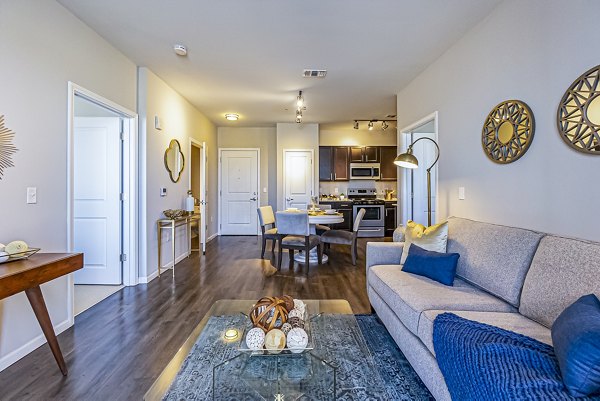 Modern living room with stylish decor and natural light at Album Quail Springs Apartments