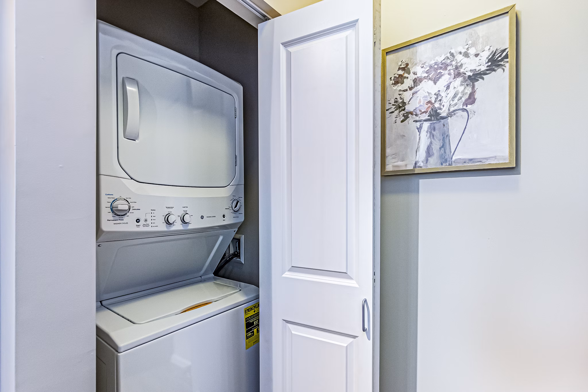 Laundry room with modern appliances at Album Quail Springs Apartments, a Greystar luxury community in Oklahoma City
