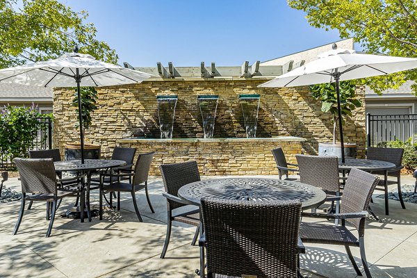 Modern outdoor patio space at Album Quail Springs Apartments with stylish seating and greenery