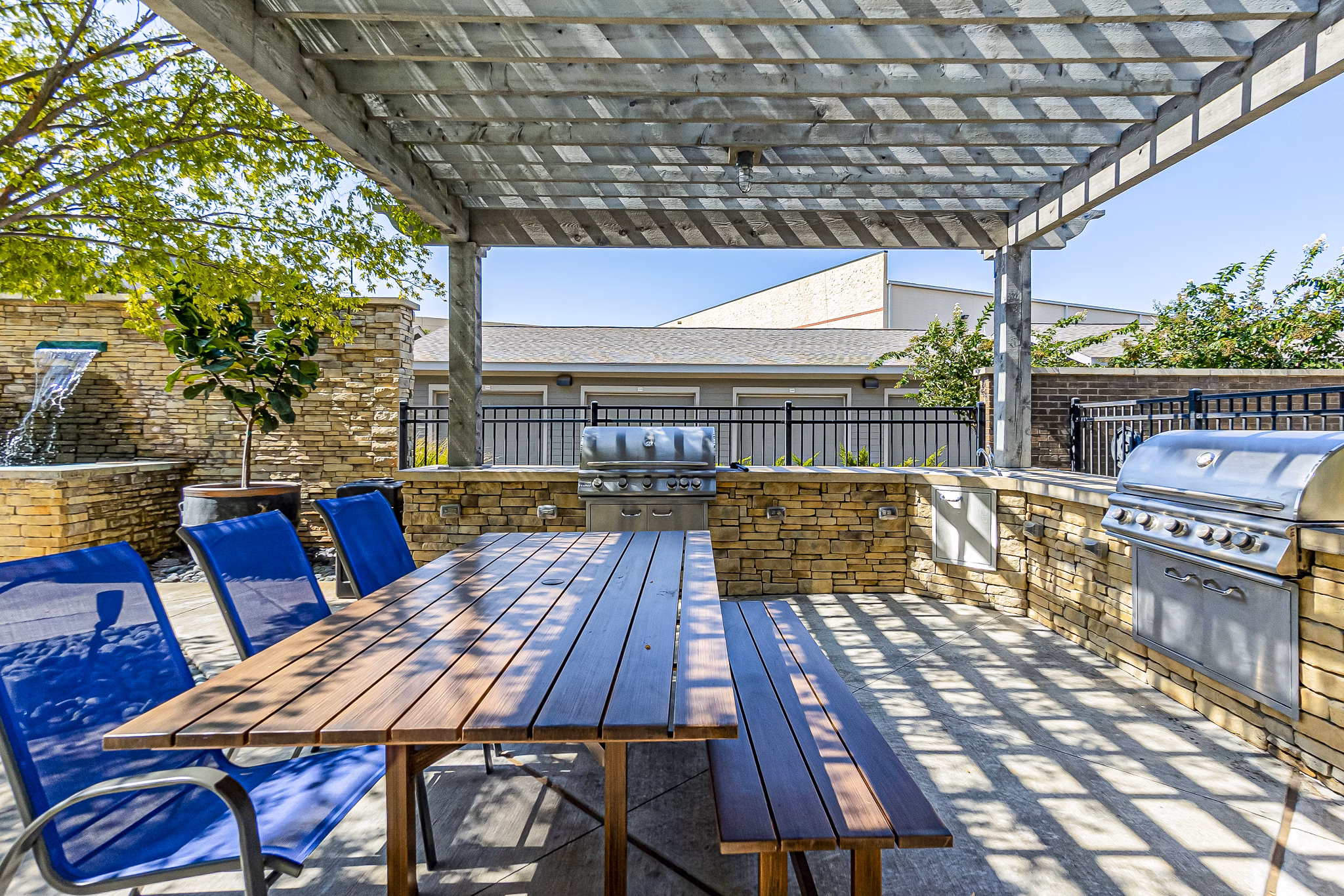 Outdoor grill area with modern seating at Album Quail Springs Apartments