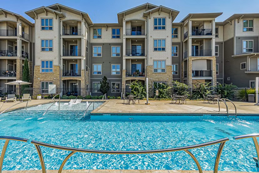 Resort-style pool with lounge seating at Album Quail Springs Apartments
