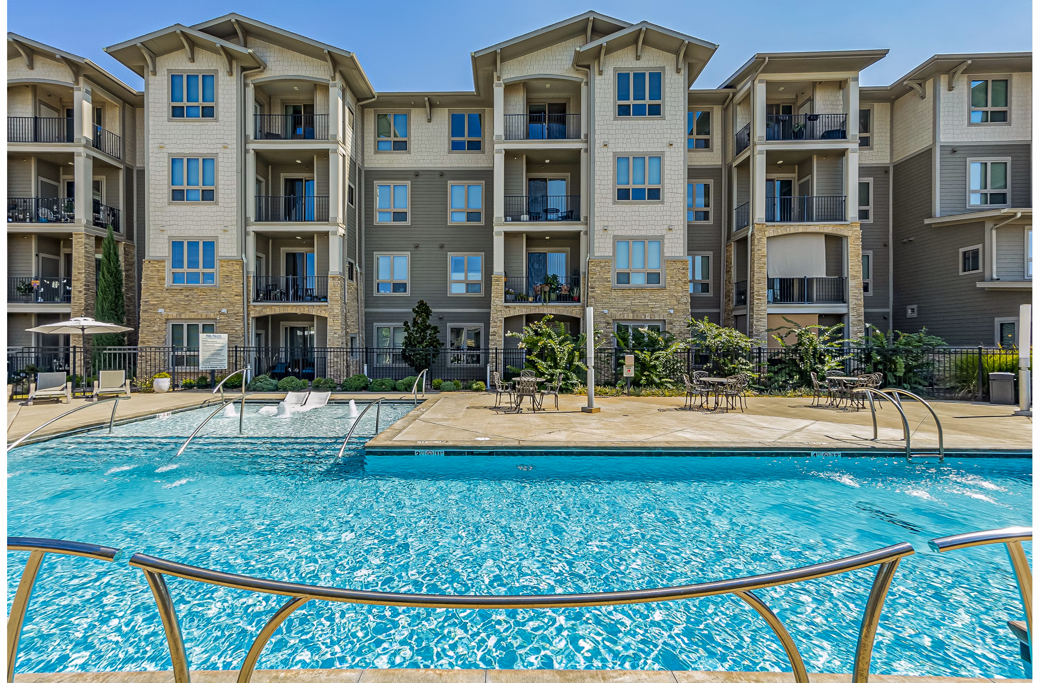 Resort-style pool with lounge seating at Album Quail Springs Apartments