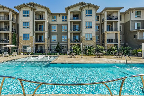Resort-style pool with lounge seating at Album Quail Springs Apartments