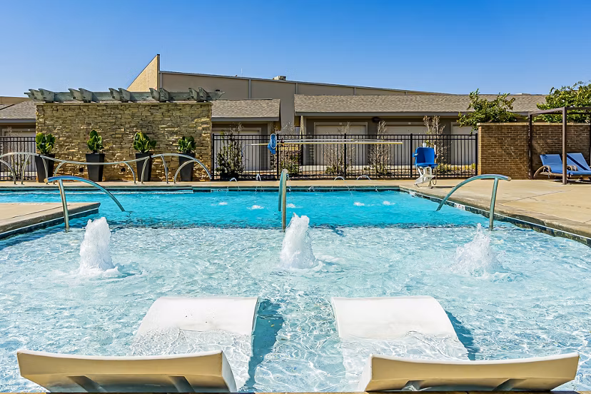 Relaxing outdoor pool at Album Quail Springs Apartments featuring lounge seating and landscaped surroundings, ideal for luxury apartment living