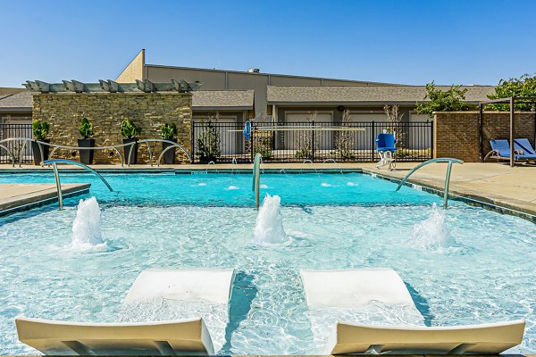 Relaxing outdoor pool at Album Quail Springs Apartments featuring lounge seating and landscaped surroundings, ideal for luxury apartment living