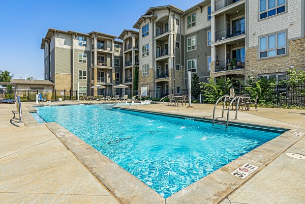 Outdoor pool with lounge chairs at Album Quail Springs Apartments