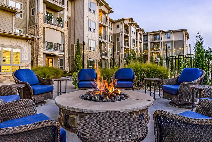 Outdoor fire pit lounge at Album Quail Springs Apartments in Edmond, ideal for socializing and relaxation