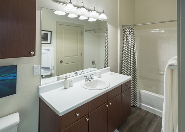 Modern bathroom with marble countertop and spacious shower in Avana on the Platte Apartments