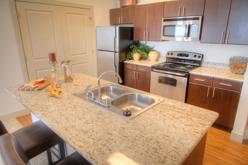Modern kitchen with stainless steel appliances at Avana on the Platte Apartments