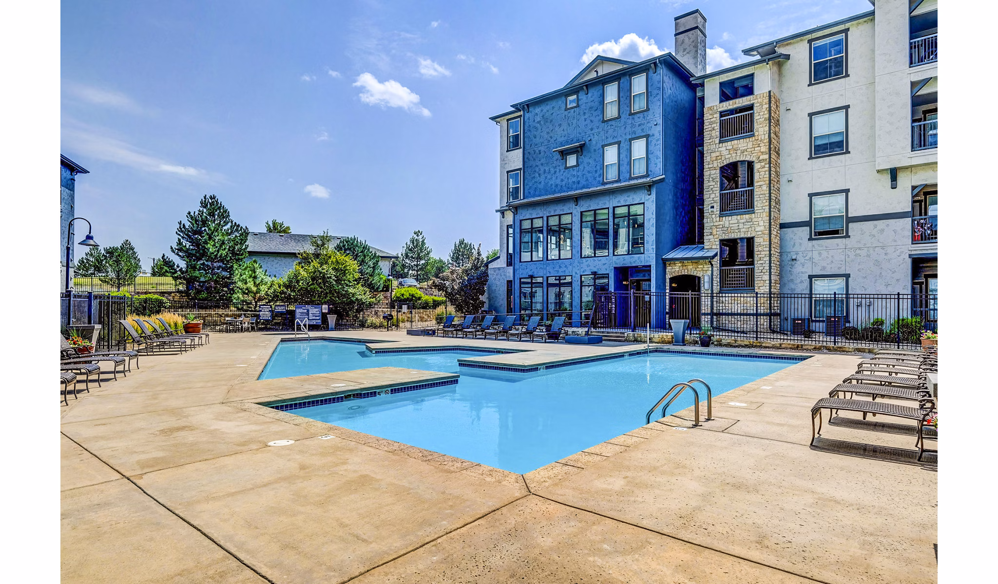 Inviting pool area with lounge seating at Avana on the Platte Apartments
