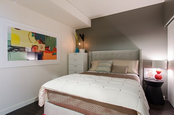 Bedroom featuring elegant decor and large windows at Viktoria Apartments in Greystar's luxury collection