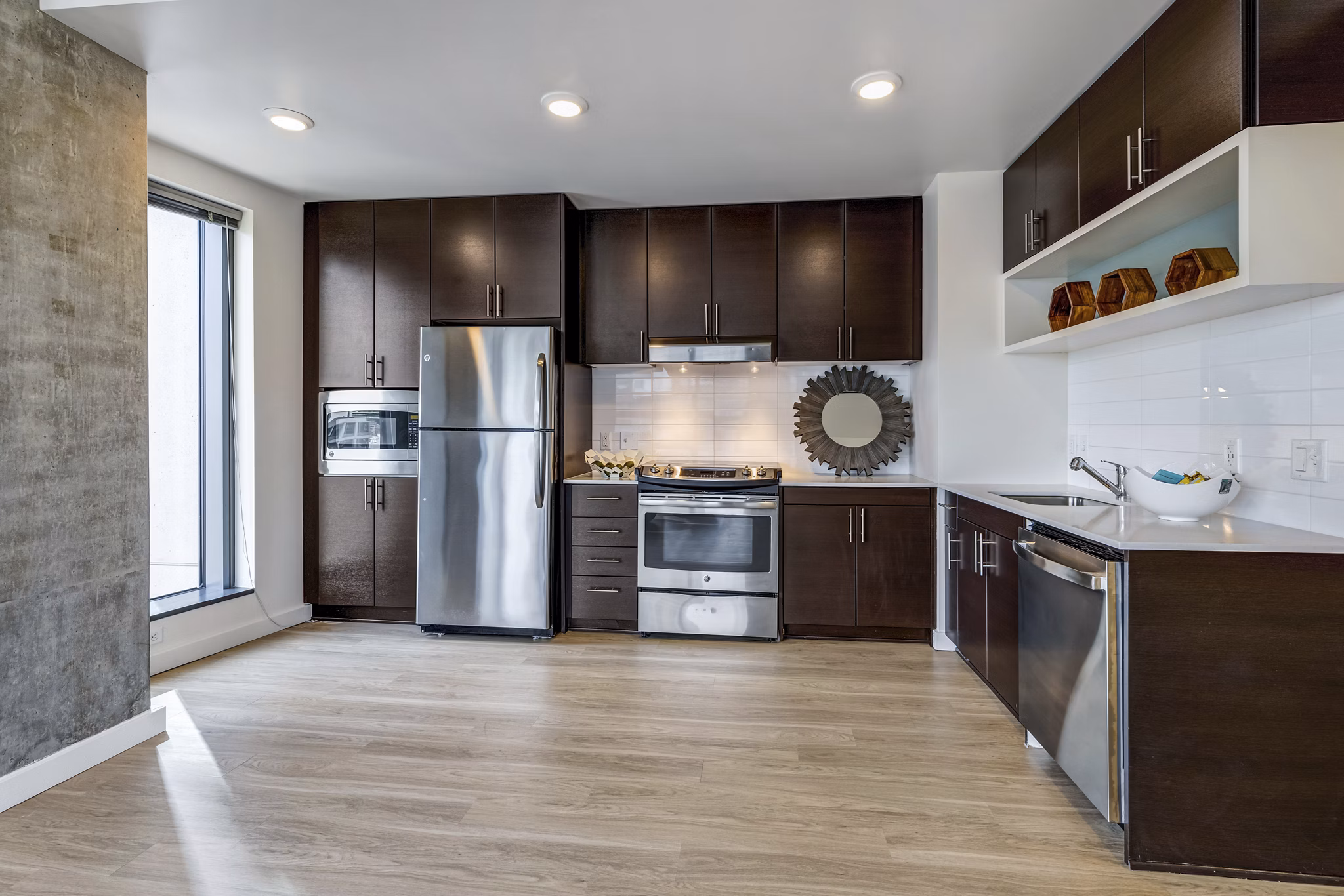 Modern kitchen with stainless steel appliances in Viktoria Apartments, a luxury Greystar property in a prime downtown location
