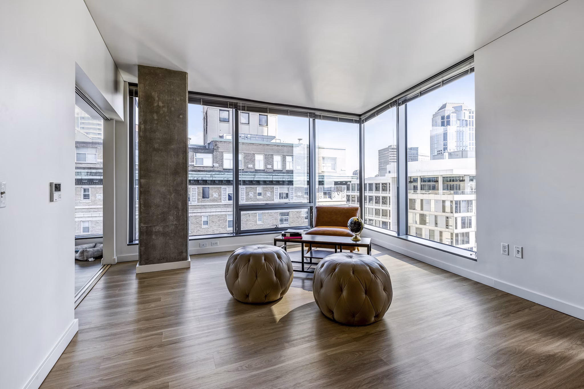Elegant living room with modern furnishings and city views at Viktoria Apartments, luxury urban living in the heart of Seattle