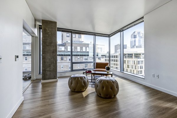 Elegant living room with modern furnishings and city views at Viktoria Apartments, luxury urban living in the heart of Seattle