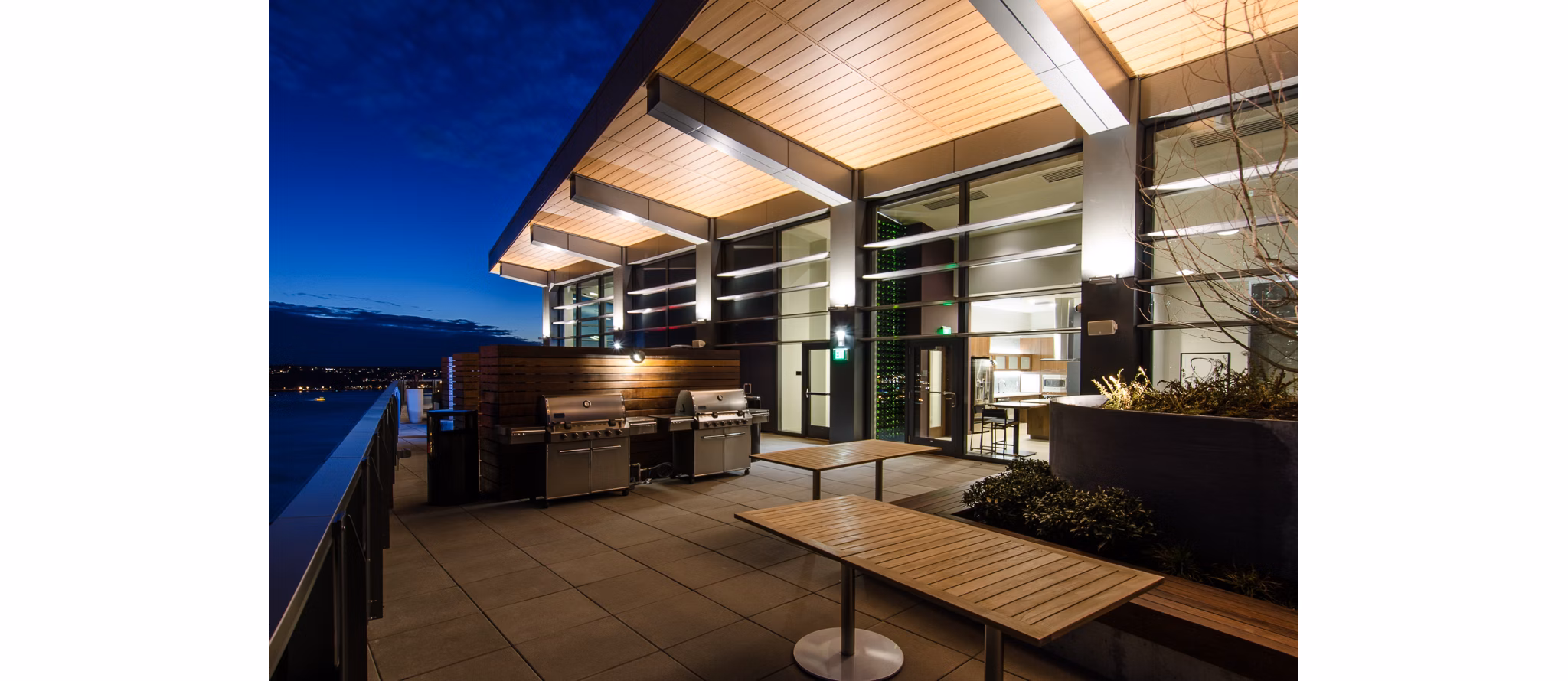 Outdoor grilling space with modern seating at Viktoria Apartments, a luxury community in downtown Seattle