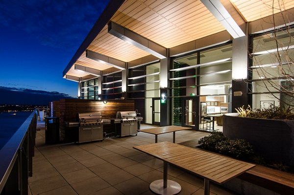 Outdoor grilling space with modern seating at Viktoria Apartments, a luxury community in downtown Seattle