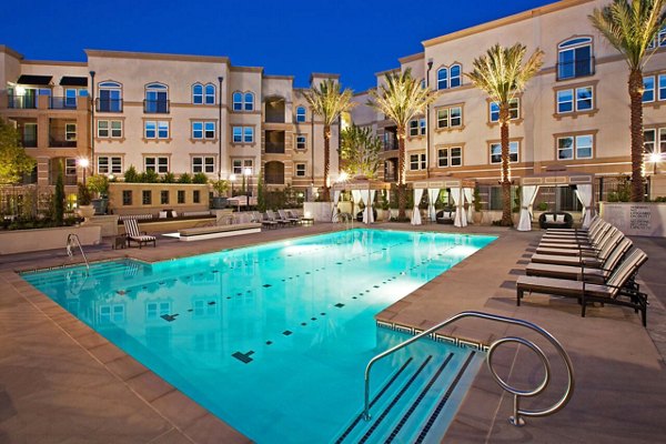 Resort-style pool with lounge chairs at Carlyle Apartments, Greystar luxury community