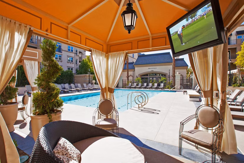 Inviting outdoor pool with sun loungers at Carlyle Apartments, a luxury living community by Greystar