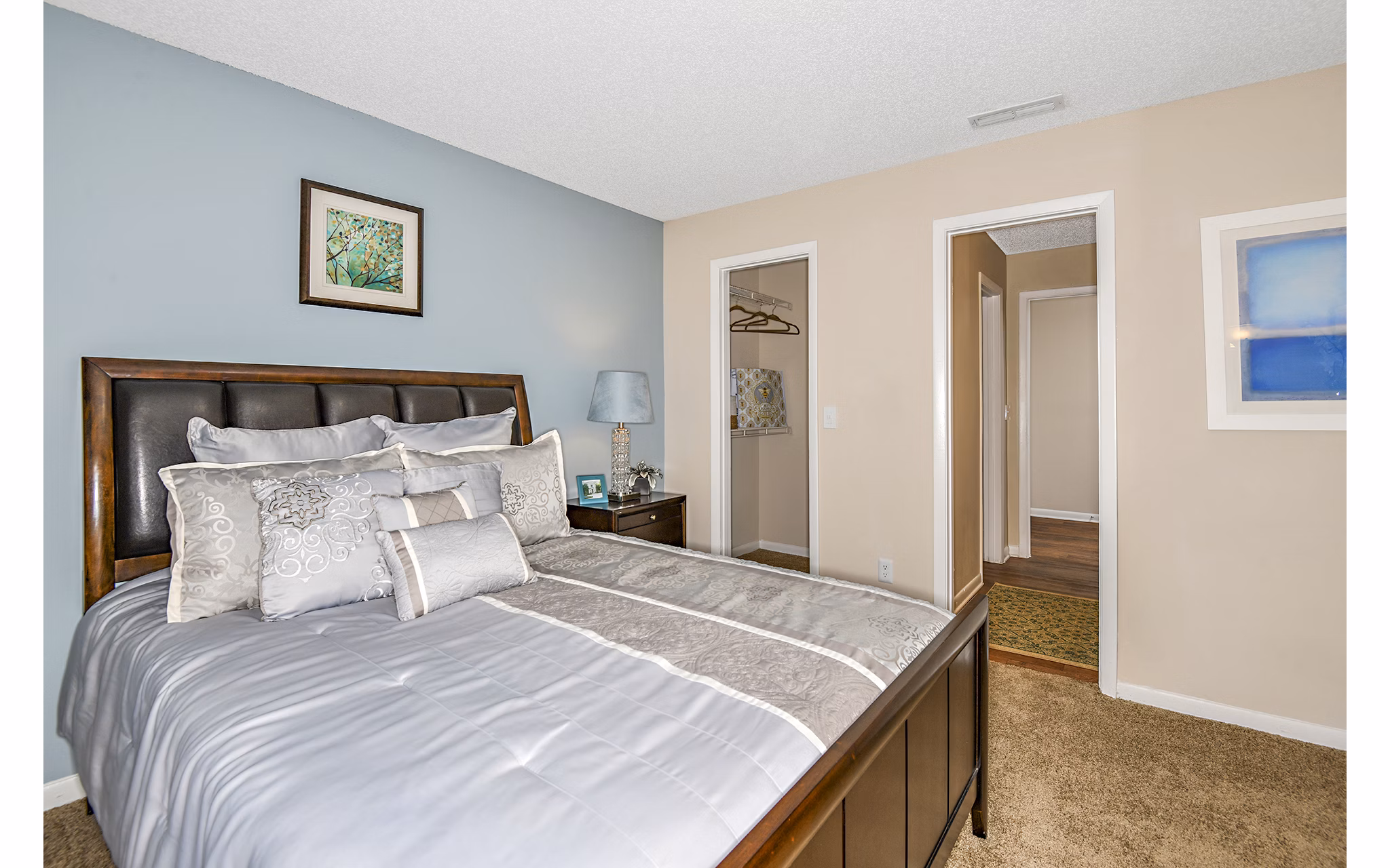 Cozy bedroom with modern furnishings at Lakeshore at Altamonte Springs Apartments