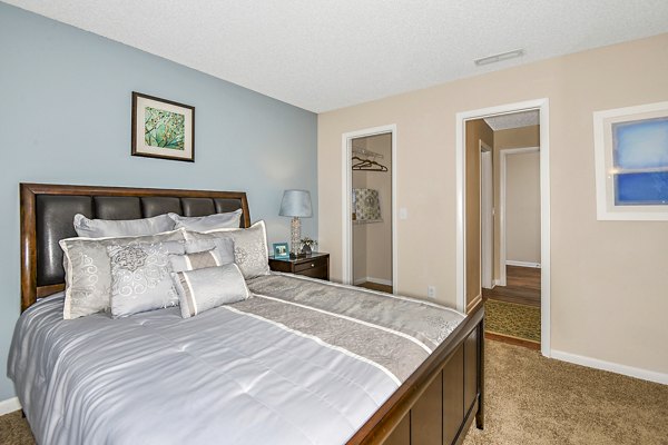 Cozy bedroom with modern furnishings at Lakeshore at Altamonte Springs Apartments