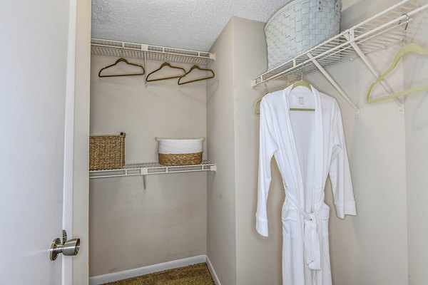 Bedroom closet with wooden shelving at Lakeshore at Altamonte Springs Apartments