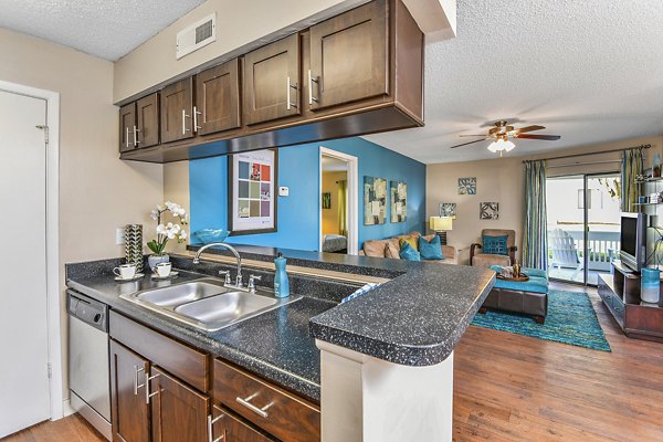 Modern kitchen with stainless steel appliances at Lakeshore at Altamonte Springs Apartments