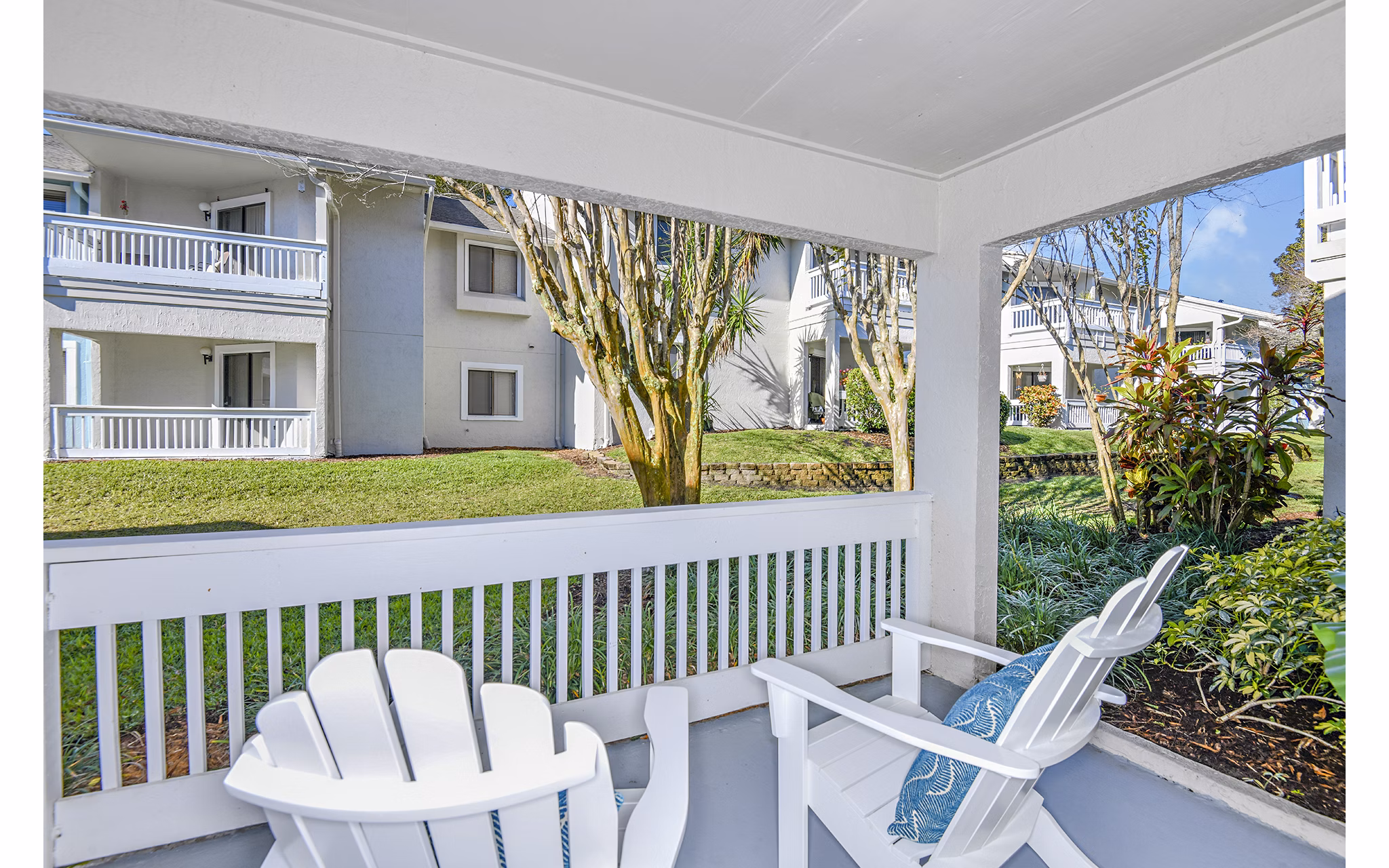 Spacious patio with garden view at Lakeshore at Altamonte Springs Apartments, ideal for relaxation and enjoying nature