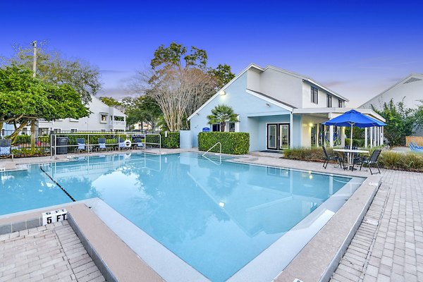 Resort-style pool with lounge chairs at Lakeshore at Altamonte Springs luxury apartments