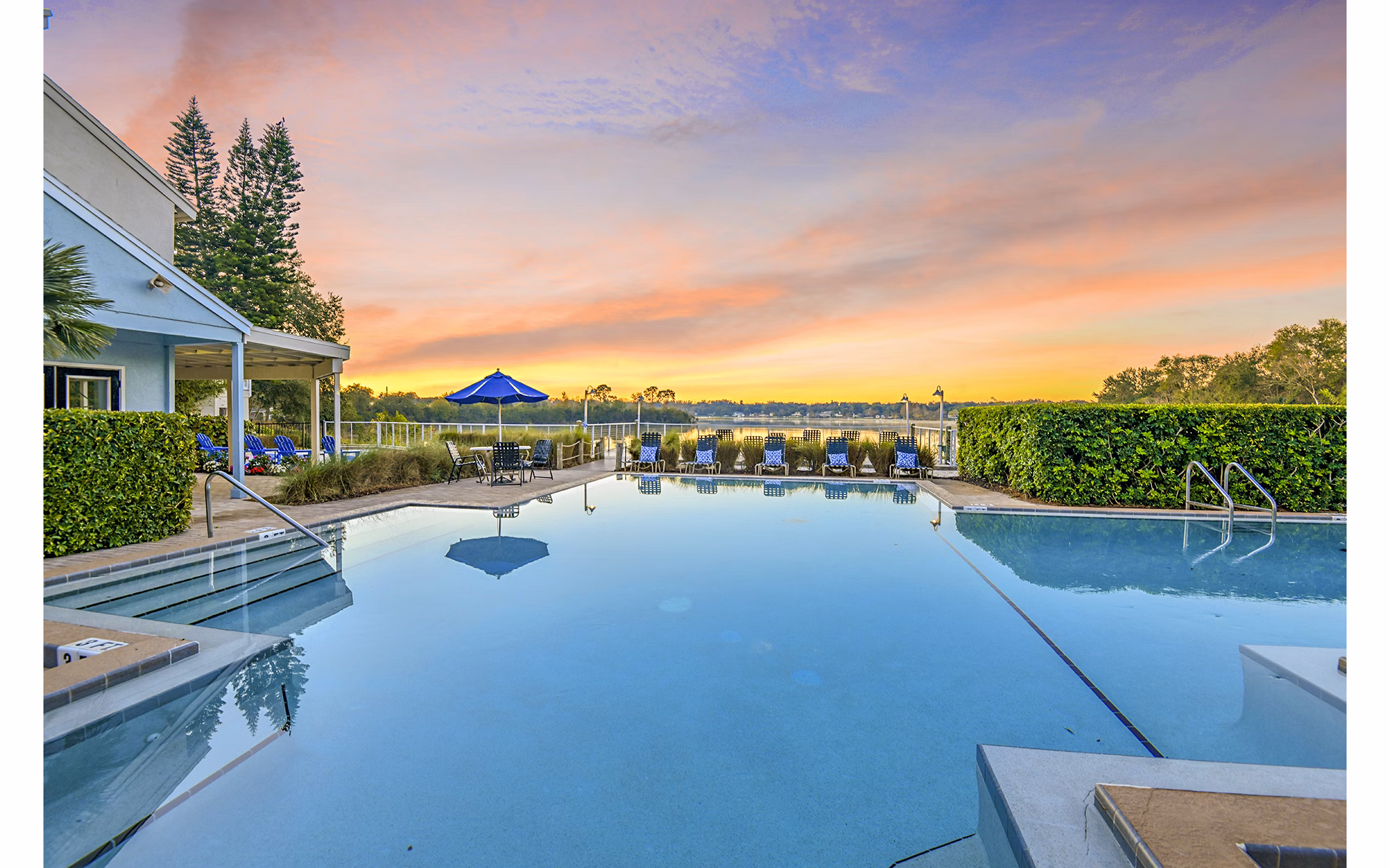 Resort-style pool with sun loungers at Lakeshore at Altamonte Springs Apartments