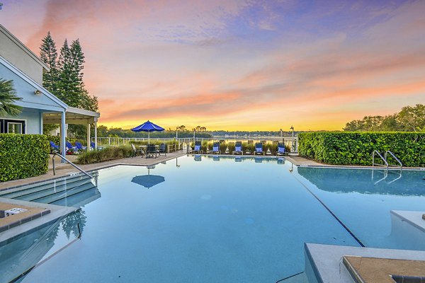 Resort-style pool with sun loungers at Lakeshore at Altamonte Springs Apartments