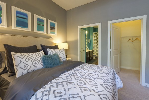 Bedroom with modern design and large windows at Junction Six Forks Apartments, offering luxury living in Raleigh