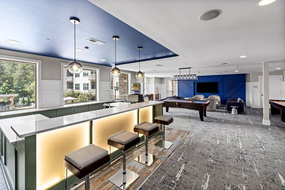 Clubhouse featuring modern decor and open seating in Junction Six Forks Apartments, perfect for social gatherings and events