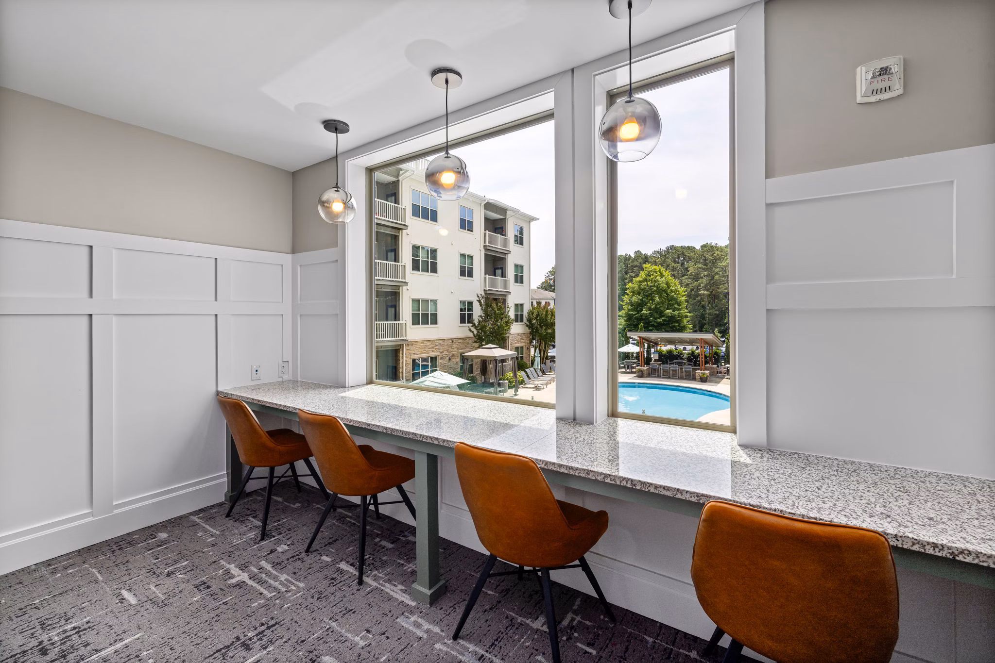 Contemporary clubhouse interior featuring open seating and modern design at Junction Six Forks luxury apartments