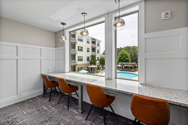 Contemporary clubhouse interior featuring open seating and modern design at Junction Six Forks luxury apartments