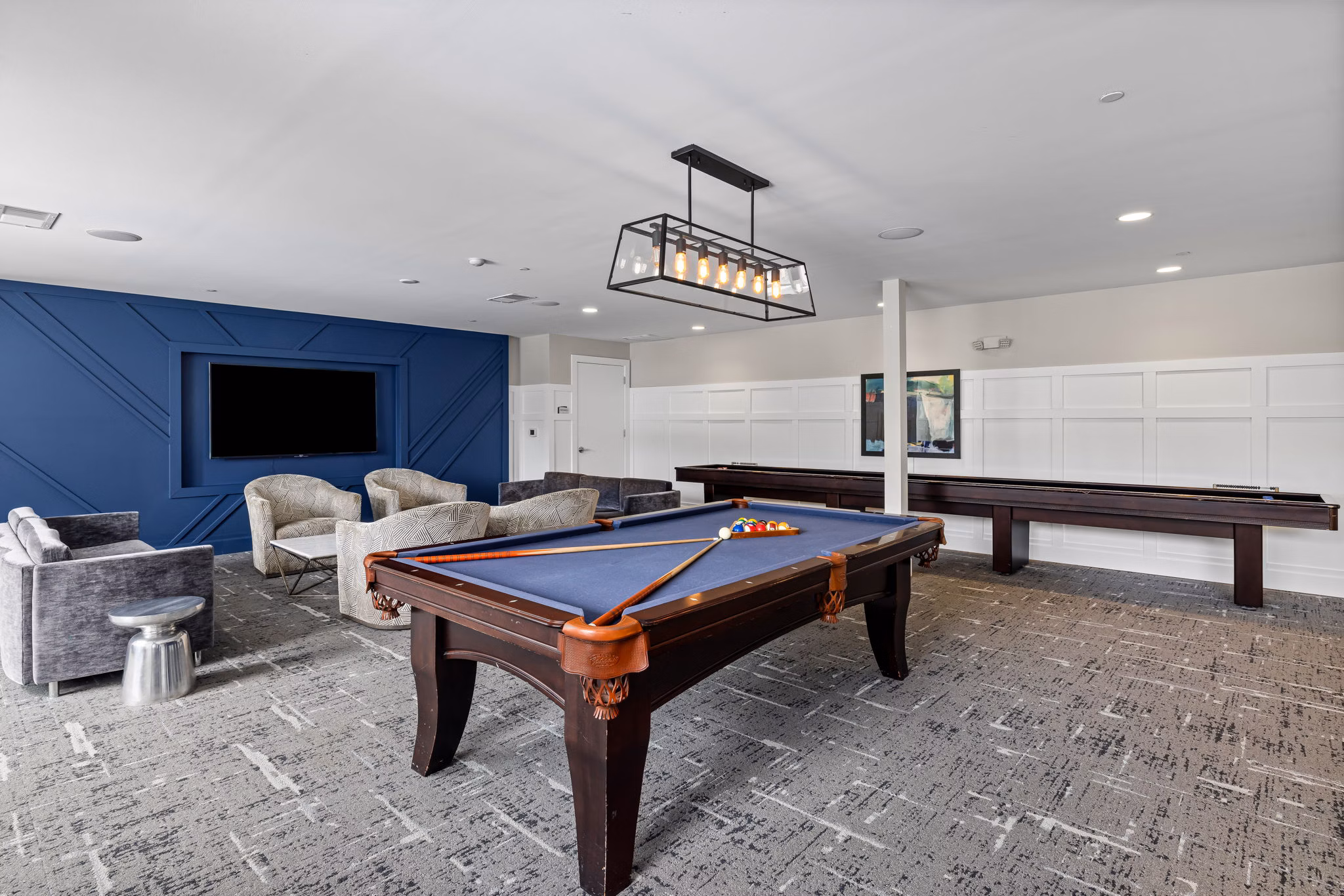 Clubhouse with modern decor and lounge seating at Junction Six Forks Apartments in Raleigh