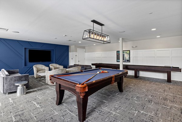 Clubhouse with modern decor and lounge seating at Junction Six Forks Apartments in Raleigh