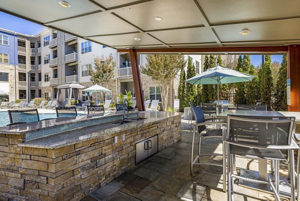 Spacious outdoor patio with modern seating at Junction Six Forks Apartments, perfect for relaxation and social gatherings