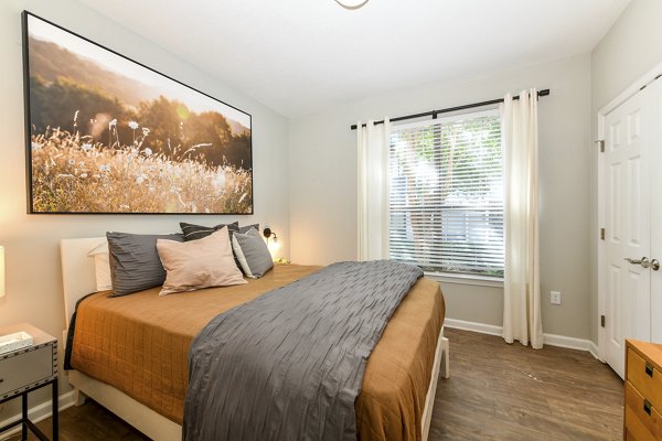 Cozy bedroom with modern decor at Avana Ridenour Apartments, offering luxury living in an inviting and comfortable setting