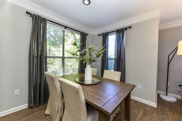 Dining area featuring modern furnishings and elegant lighting in Avana Ridenour Apartments