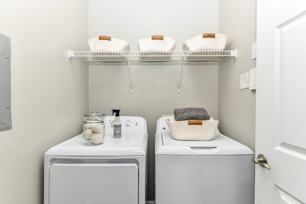 Laundry room featuring modern appliances at Avana Ridenour Apartments