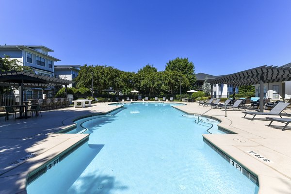 Refreshing outdoor pool at Avana Ridenour Apartments, offering a serene retreat for residents