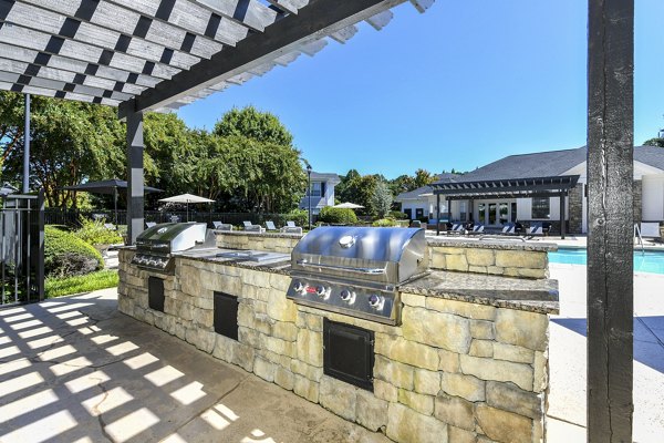 Outdoor grill area with modern seating at Avana Ridenour Apartments