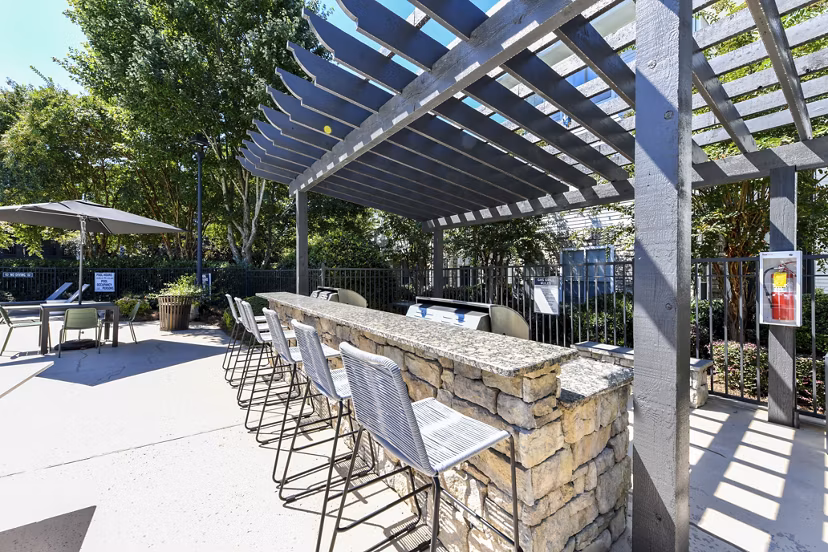 Outdoor social area with BBQ grills at Avana Ridenour Apartments, ideal for gatherings and relaxation