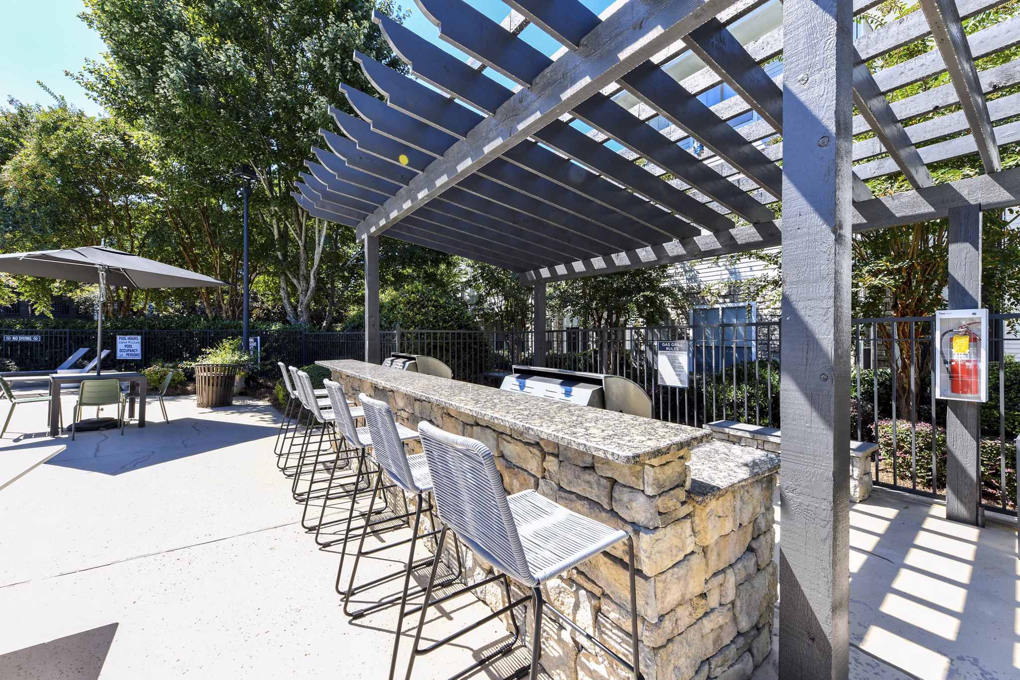Outdoor social area with BBQ grills at Avana Ridenour Apartments, ideal for gatherings and relaxation