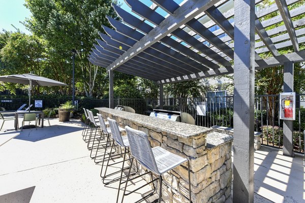 Outdoor social area with BBQ grills at Avana Ridenour Apartments, ideal for gatherings and relaxation