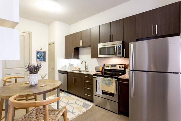 Modern kitchen with stainless steel appliances at Azul Lakeshore Apartments