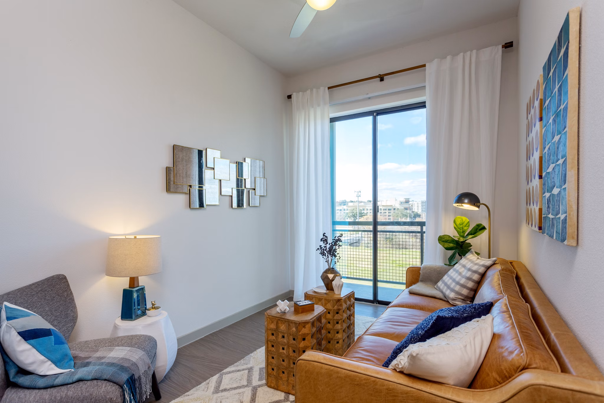 Spacious living room with modern decor and large windows in Azul Lakeshore Apartments